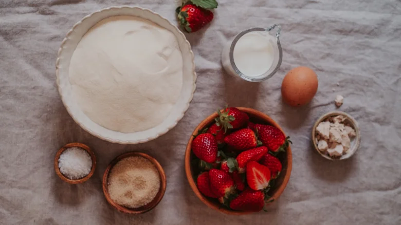Ingredience pro kynuté jahodové knedlíky: mouka, mléko, vejce, cukr, sůl, jahody a sušenky