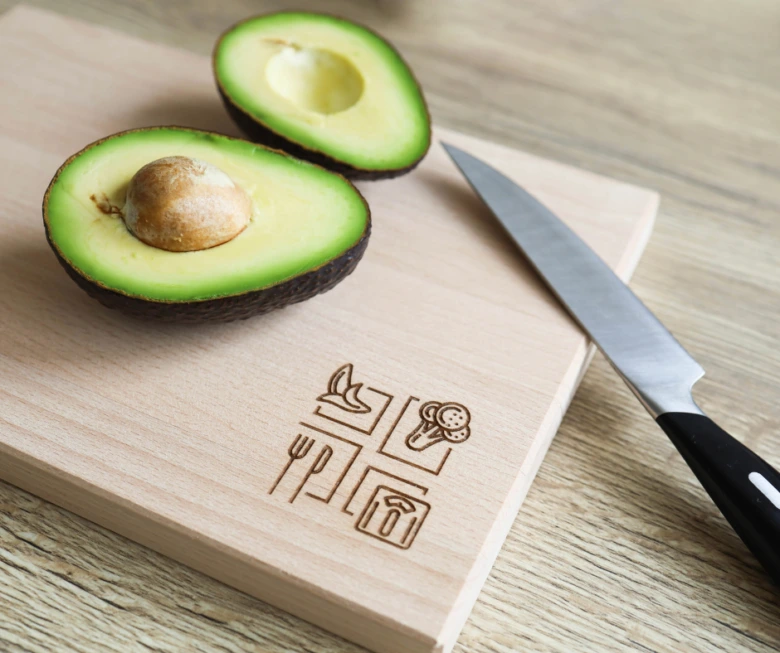 Avocado halves on cutting board